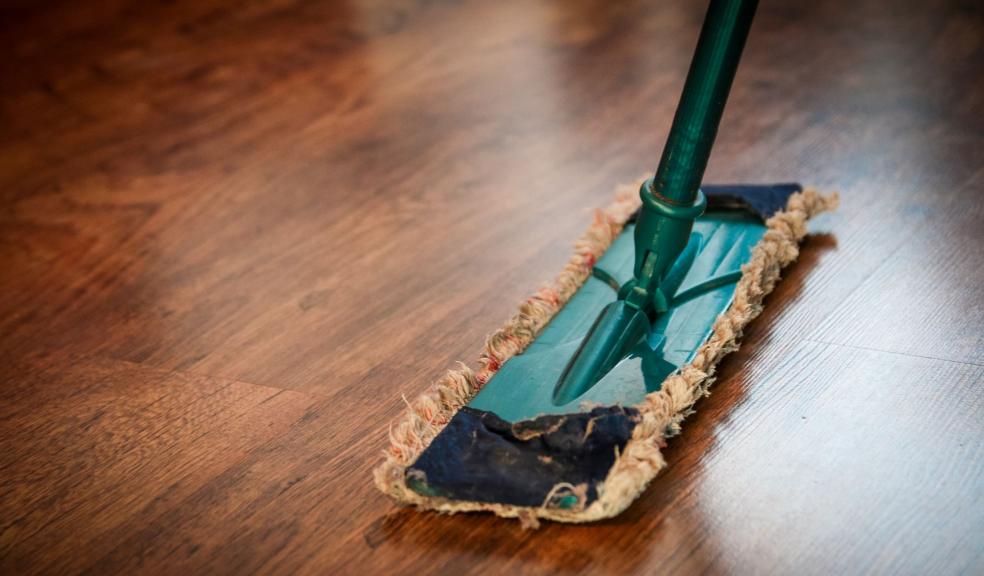 Brown wooden floor being cleaned Brown wooden floor being cleaned
